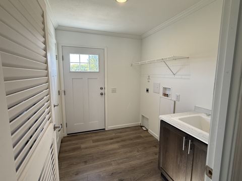 Laundry room with utility sink, cabinet and exterior door