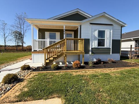 Front of the home with covered porch and steps